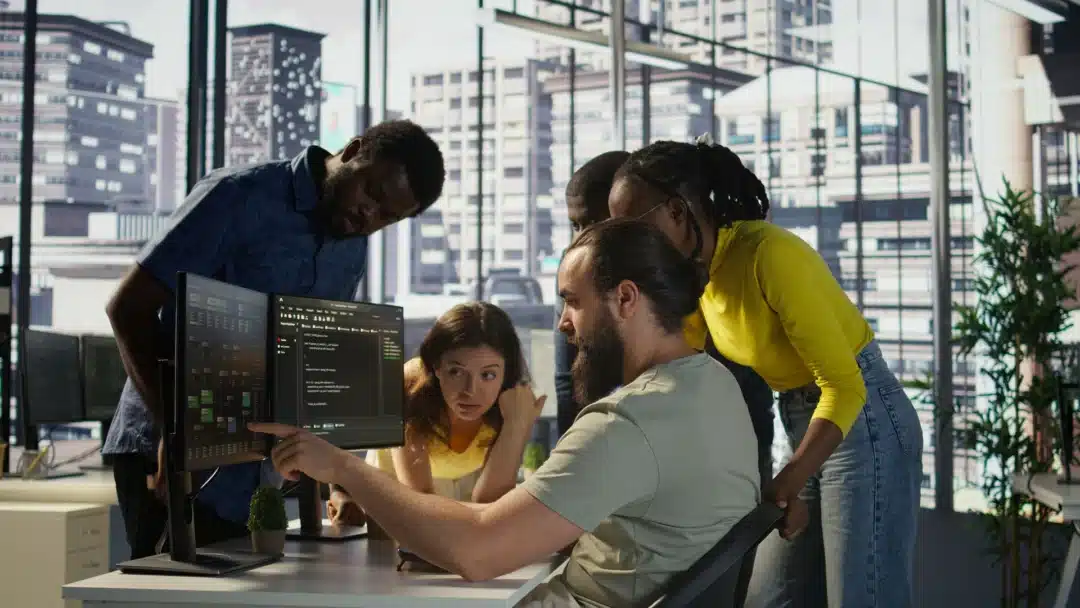 Image of a team of developers collaborating on technology projects under an IT staffing model